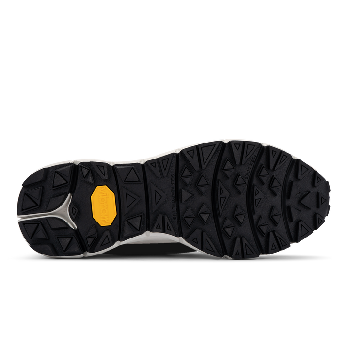 vibram self adaptive rubber lug technology. Black outsole white midsole yellow vibram crest logo