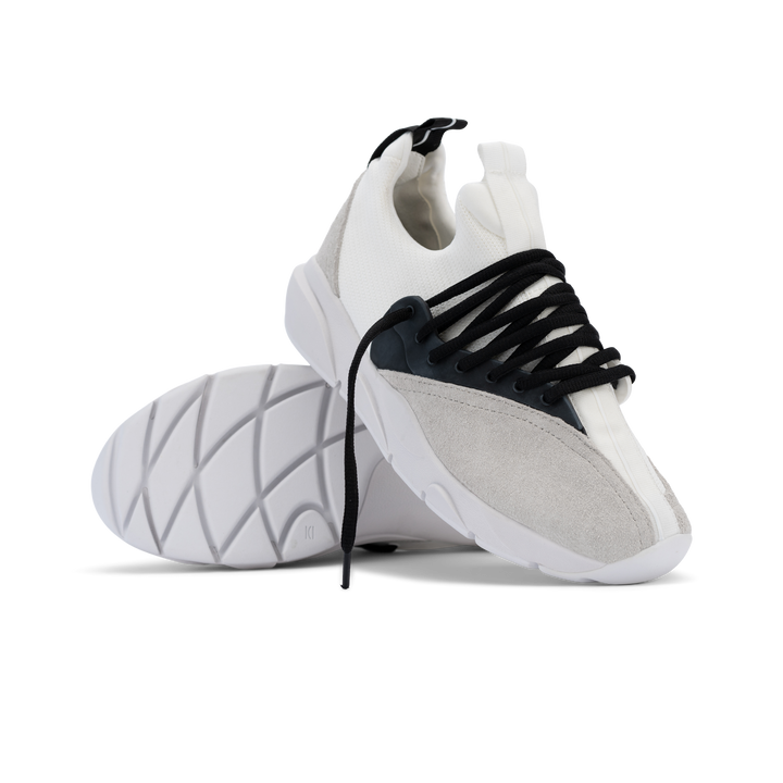 Stylized shot, Cloudstryk Fairbanks is a runner with White suede overlays white stretch mesh underlays, Black heel pull molded lace holder, white eva midsol and white rubber outsole.
