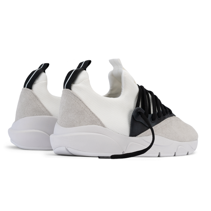 Back 3/4 view, Cloudstryk Fairbanks is a runner with White suede overlays white stretch mesh underlays, Black heel pull molded lace holder, white eva midsol and white rubber outsole.