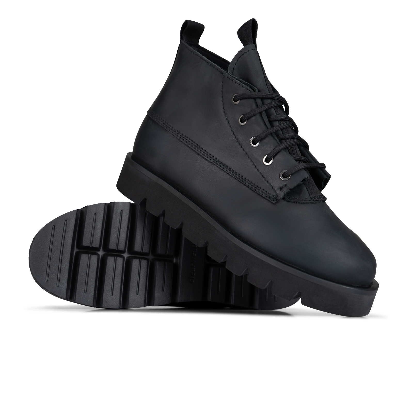 A pair of black leather lace-up ankle boots with chunky lug soles, shown on a clean white background with one boot standing upright and the other lying on its side to display the sole.