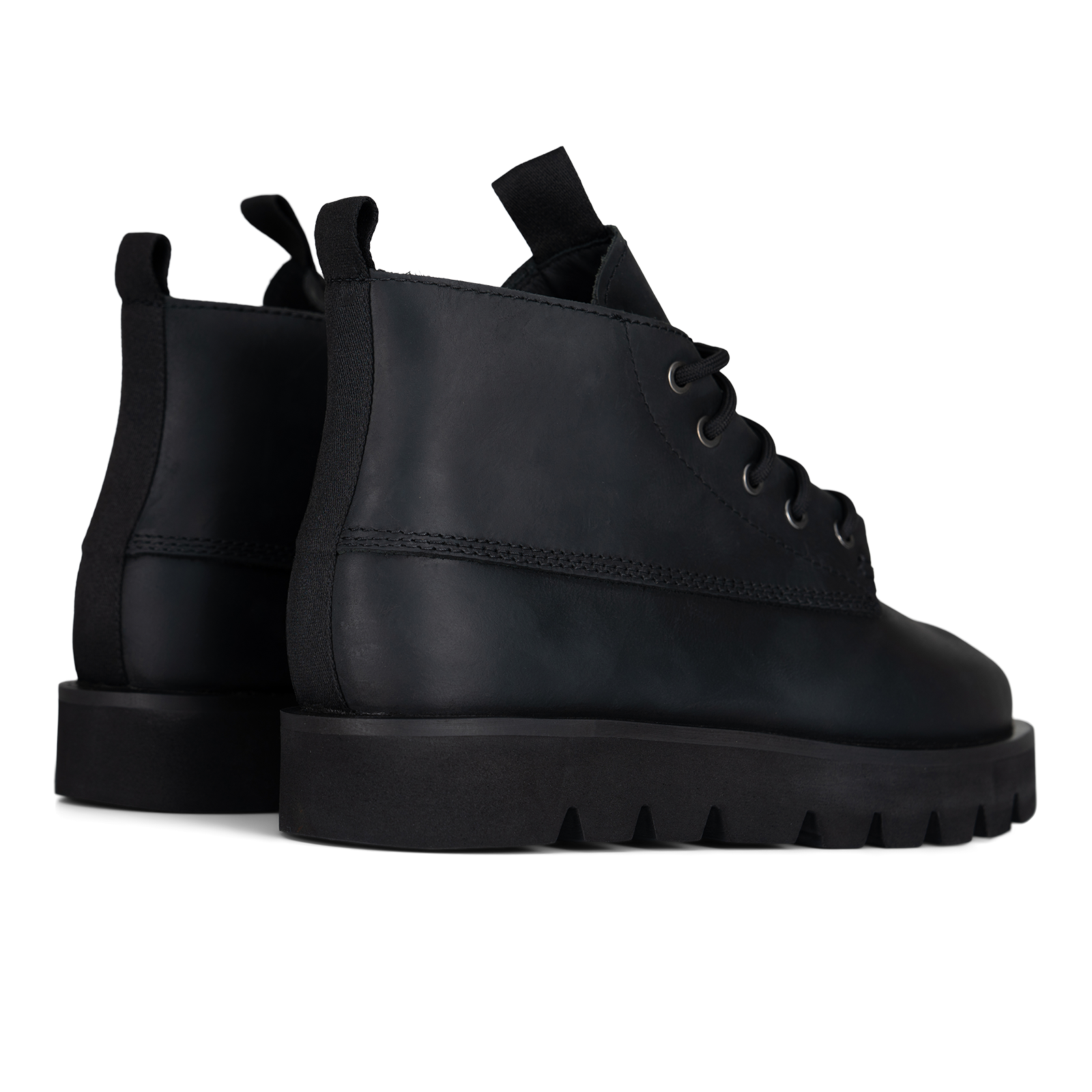 A pair of black leather lace-up ankle boots with chunky lug soles, shown from a side and rear three-quarter angle on a plain white background.