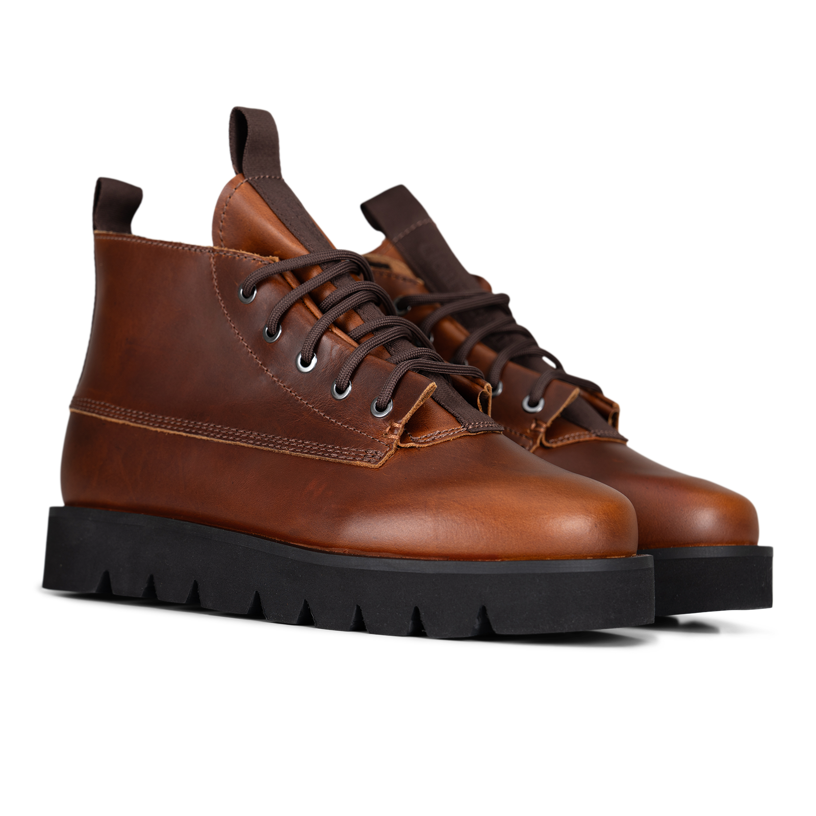A pair of brown leather lace-up ankle boots with black lug soles, shown on a clean white background.