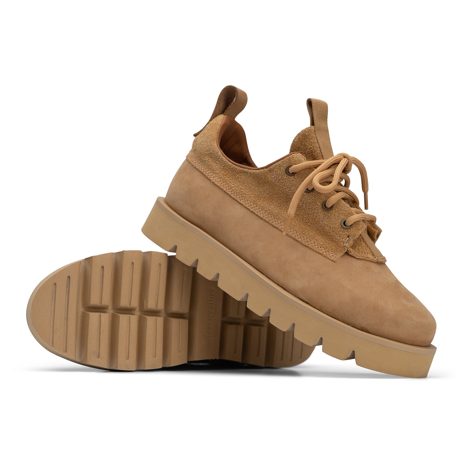 Brown suede shoes with thick soles on a white background