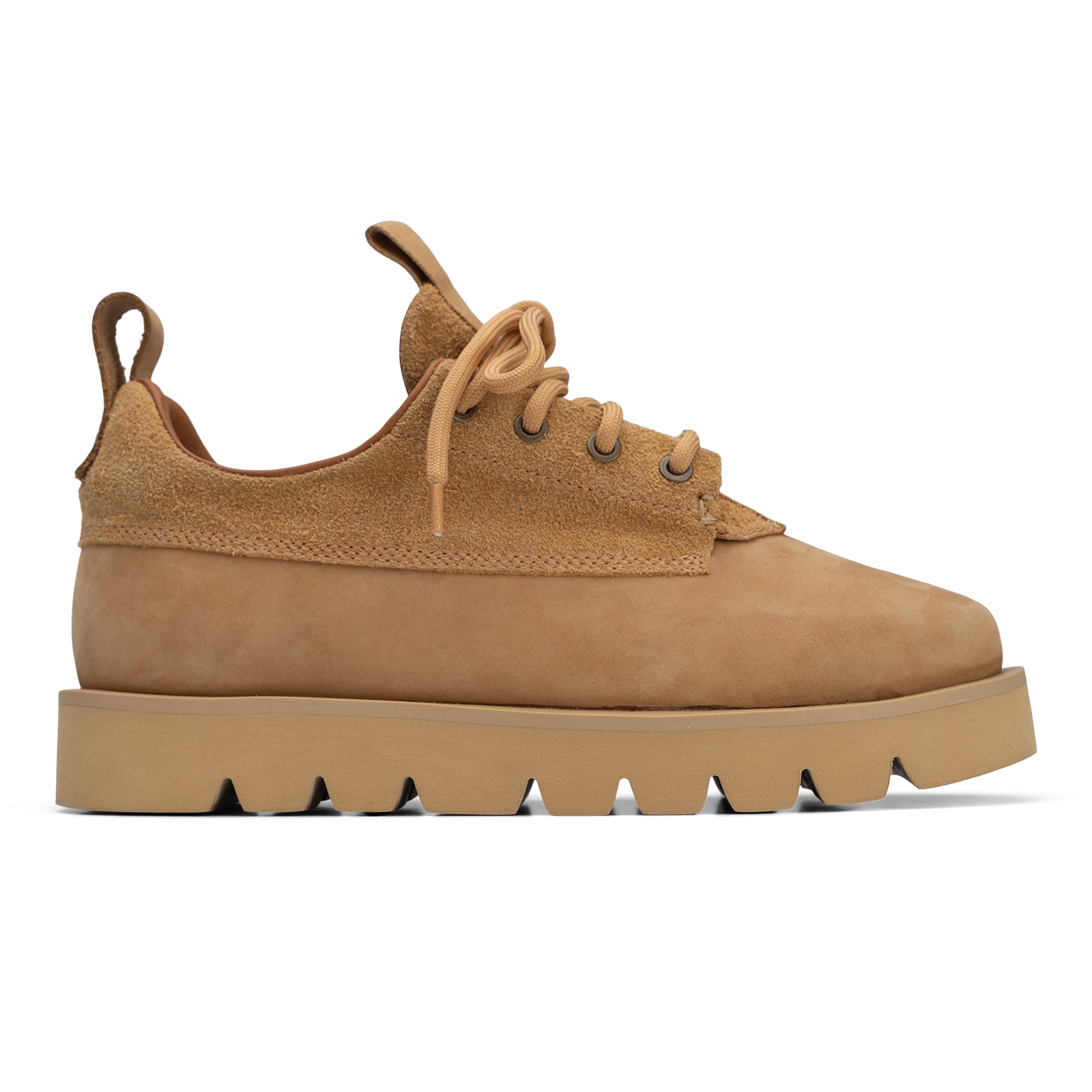 Tan suede sneaker with thick sole on a white background