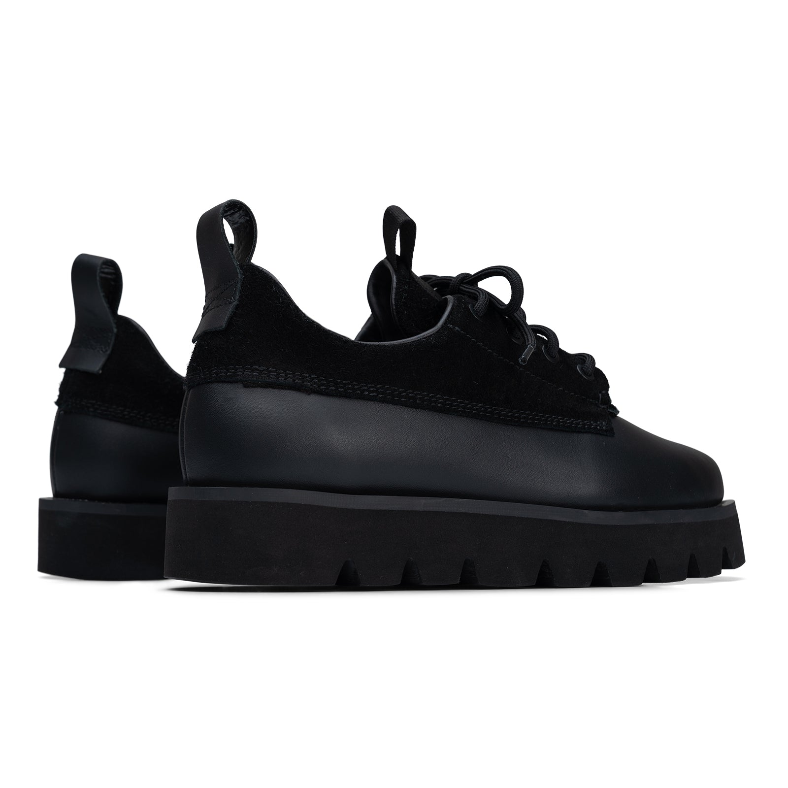 Black platform sneakers on a white background