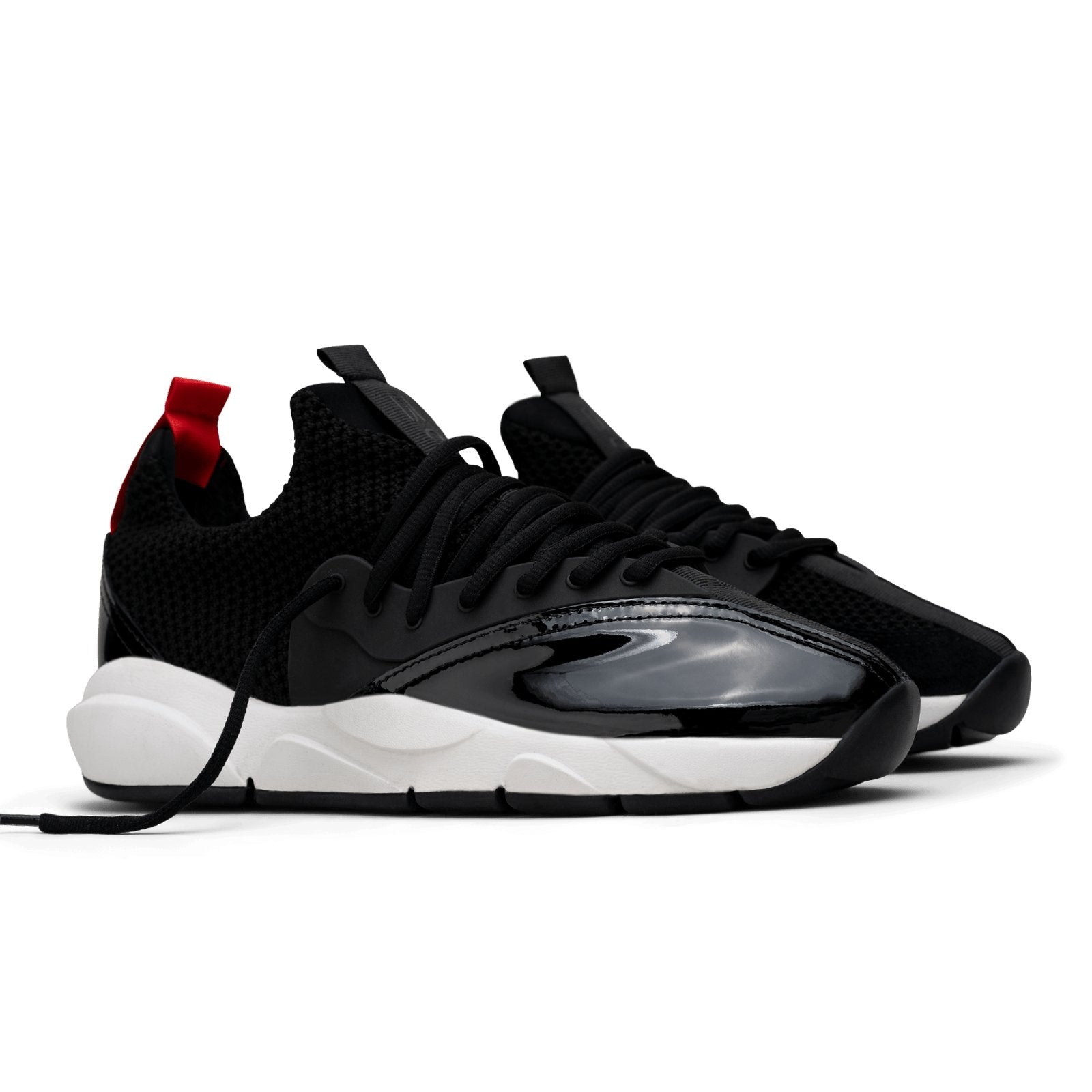 3/4 view, Cloudstryk Advantage is a runner with Black patent leather and suede overlays zoom mesh underlays, red heel pull molded lace holder, white eva midsol and a translucent black rubber outsole.