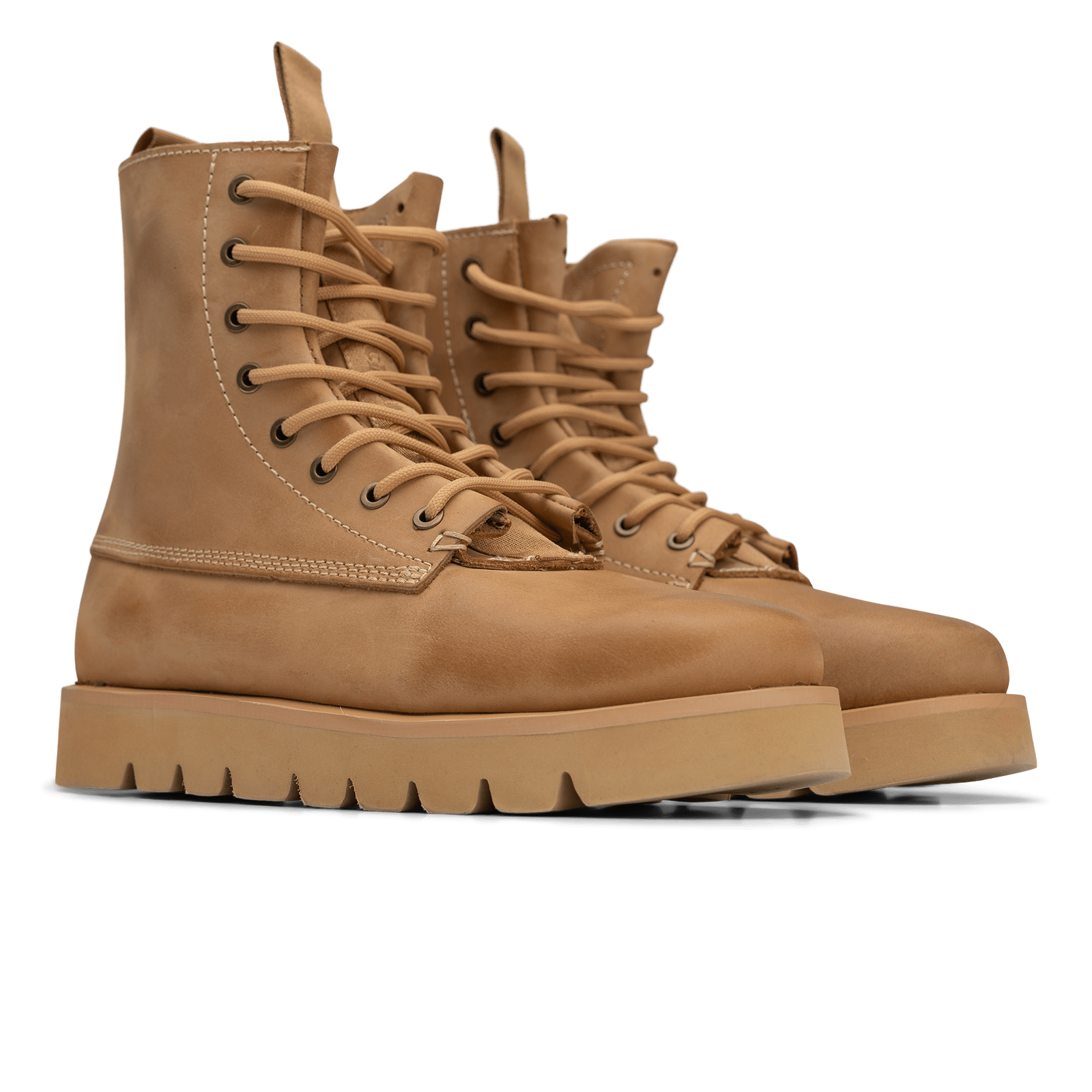 Pair of tan leather boots with thick soles on a white background