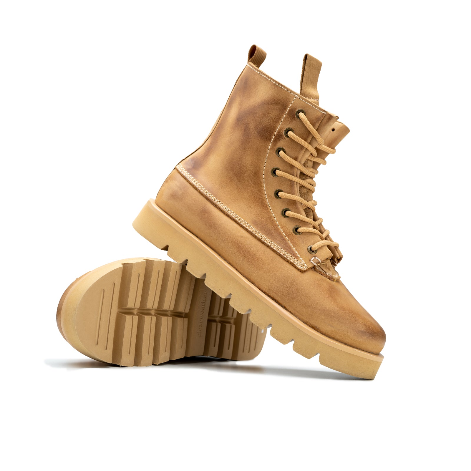 Pair of tan leather boots on a white background