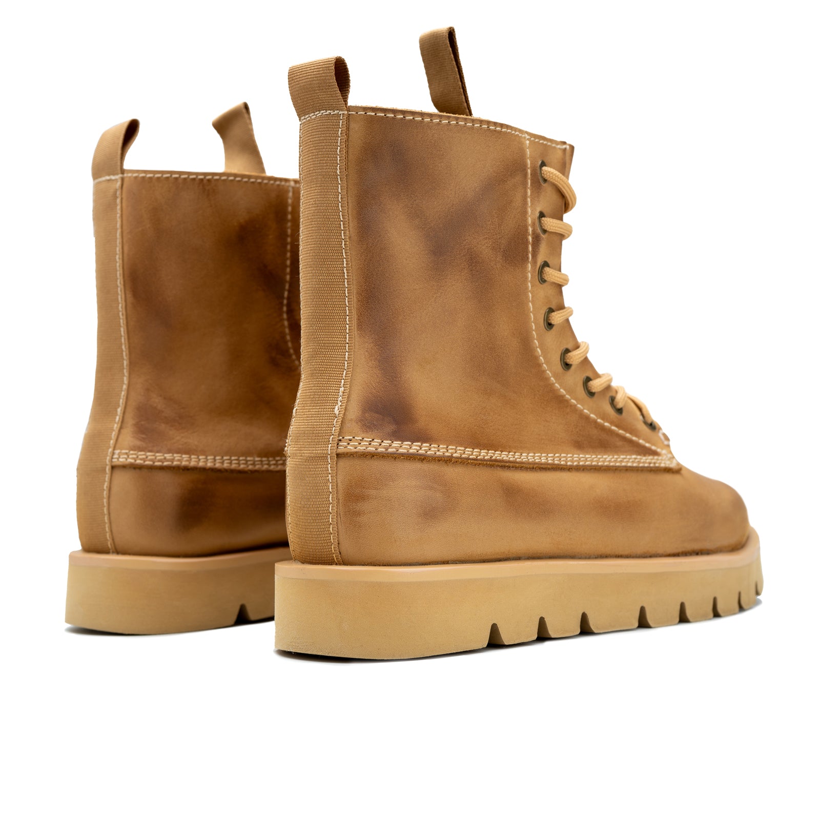 Pair of brown leather boots on a white background