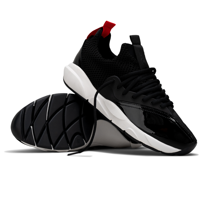 stylized view, Cloudstryk Advantage is a runner with Black patent leather and suede overlays zoom mesh underlays, red heel pull molded lace holder, white eva midsol and a translucent black rubber outsole.