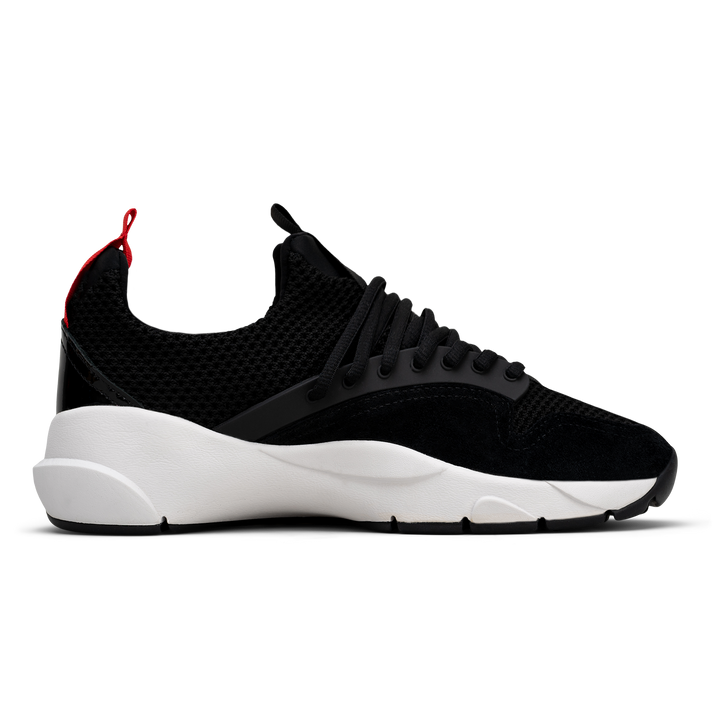 Inside view. Cloudstryk Advantage is a runner with Black patent leather and suede overlays zoom mesh underlays, red heel pull molded lace holder, white eva midsol and a translucent black rubber outsole.