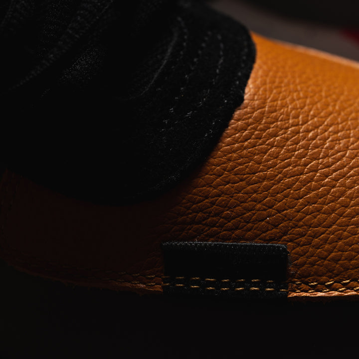 macro shots, The Contera Kalahari is a Runner with grey leather black suede and tabaco orange leather, Blue webbing heel pull, Black webbin tongue pull, Black webbing lace system, painted eva midsole ande black rubber outsole.