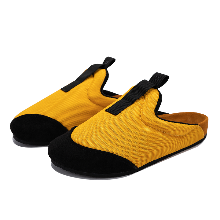 3/4 view Bantha 2.0 Yellow is a Mule made of Yellow mesh with a Black hairy suede to overlay, cork midsole with suede top lining Black VIbram rubber bottom and woven top pull